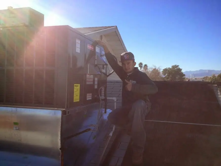 HVAC technician performing HVAC Inspection on a rooftop unit in Vandalia